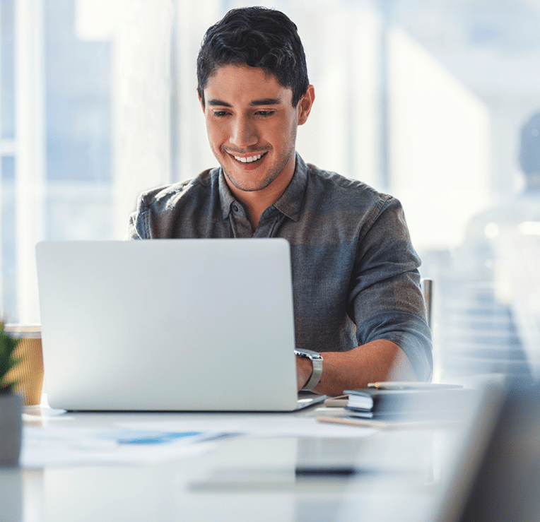 Business owner on his computer happy with his financial performance.